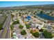 Residential area view featuring neighborhood streets, lush trees, a pond with a fountain, and a single-Gathering home at 14901 Wild Wood Lily Ct, Orlando, FL 32824
