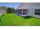 Spacious backyard featuring a screened-in lanai and lush green grass at 14901 Wild Wood Lily Ct, Orlando, FL 32824