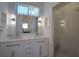 Bright bathroom with double sinks, quartz countertop, modern fixtures, and a glass shower at 14901 Wild Wood Lily Ct, Orlando, FL 32824