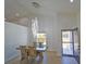 Bright dining room featuring tile flooring, modern lighting, and direct access to the front entrance at 14901 Wild Wood Lily Ct, Orlando, FL 32824