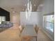 Dining room with a modern chandelier, tile flooring, and an adjoining living room at 14901 Wild Wood Lily Ct, Orlando, FL 32824