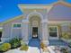 Close-up of the front entrance highlighting the arched entryway, black door, and landscaping at 14901 Wild Wood Lily Ct, Orlando, FL 32824