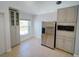 Kitchen area with stainless steel refrigerator, updated cabinets, and a window for natural light at 14901 Wild Wood Lily Ct, Orlando, FL 32824