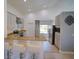 Well-lit kitchen with granite countertops, white cabinetry, and a breakfast bar area at 14901 Wild Wood Lily Ct, Orlando, FL 32824