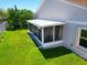 Elevated angle of a screened-in lanai overlooking a lush green backyard at 14901 Wild Wood Lily Ct, Orlando, FL 32824