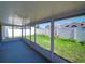 Enclosed lanai featuring screens and views of the backyard and garden at 14901 Wild Wood Lily Ct, Orlando, FL 32824