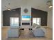 Inviting living room featuring comfortable seating, a fireplace, and a view of the enclosed patio at 14901 Wild Wood Lily Ct, Orlando, FL 32824