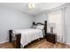Cozy bedroom with wooden floors, ceiling fan, and a classic wooden bed frame at 1562 Woodwind Dr, Apopka, FL 32703