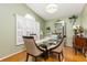 Elegant dining room showcasing bamboo floors, natural light, and stylish decor at 1562 Woodwind Dr, Apopka, FL 32703