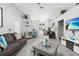 Open living room features modern gray wood floors, vaulted ceilings, and neutral color palette at 1562 Woodwind Dr, Apopka, FL 32703