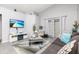 Bright living room featuring vaulted ceilings, grey wood floors and recessed architectural details at 1562 Woodwind Dr, Apopka, FL 32703