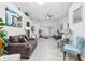 Spacious living room features modern gray wood floors, ceiling fan, and neutral color palette at 1562 Woodwind Dr, Apopka, FL 32703