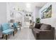Open-concept living room with neutral color palette and access to dining and entry areas at 1562 Woodwind Dr, Apopka, FL 32703