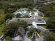 Aerial view showcasing a sprawling community clubhouse with a large pool and surrounding lush greenery at 1686 Victoria Gardens Dr, Deland, FL 32724