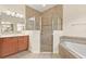 Elegant bathroom features a glass shower, soaking tub, and double vanity with modern fixtures at 1686 Victoria Gardens Dr, Deland, FL 32724