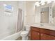 Bright bathroom with shower/tub combo, wooden cabinets, and neutral fixtures at 1686 Victoria Gardens Dr, Deland, FL 32724
