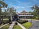 Beautifully landscaped clubhouse exterior with inviting entrance and meticulously maintained grounds at 1686 Victoria Gardens Dr, Deland, FL 32724