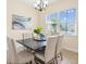 Bright dining room with natural light, modern chandelier, and comfortable seating for Gathering gatherings and meals at 1686 Victoria Gardens Dr, Deland, FL 32724