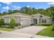 Charming single-story home featuring a brick driveway, two-car garage, manicured landscaping, and a neutral color palette at 1686 Victoria Gardens Dr, Deland, FL 32724