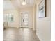 Bright foyer featuring tile flooring, an ornate front door, and arched doorways, offering a welcoming entrance at 1686 Victoria Gardens Dr, Deland, FL 32724