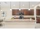 Bright kitchen features a large island, pendant lighting, and updated appliances for a modern look at 1686 Victoria Gardens Dr, Deland, FL 32724
