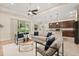 Open living room with comfortable seating, sliding glass doors to the patio, and a seamless flow to the kitchen at 1686 Victoria Gardens Dr, Deland, FL 32724