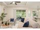 Bright living room with a sliding glass door that opens to a covered patio, and comfortable modern furnishings at 1686 Victoria Gardens Dr, Deland, FL 32724