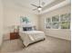 This main bedroom features a tray ceiling, a large window, and is decorated in neutral tones at 1686 Victoria Gardens Dr, Deland, FL 32724