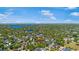 Lush green neighborhood with lake view and tennis courts as seen from above under a blue sky at 1701 Palmer Ave, Winter Park, FL 32789
