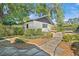 Charming backyard area featuring lush landscaping, a stone path and a detached structure at 1701 Palmer Ave, Winter Park, FL 32789