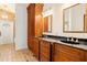 Bathroom showcasing a dual sink vanity, wooden cabinets and granite countertops at 1701 Palmer Ave, Winter Park, FL 32789
