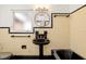 Classic bathroom with black and white tile, pedestal sink, and round mirror at 1701 Palmer Ave, Winter Park, FL 32789