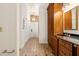 Bathroom leading into the entryway with tile flooring and wooden cabinets at 1701 Palmer Ave, Winter Park, FL 32789