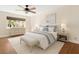 Stylishly furnished bedroom featuring a ceiling fan, a large bed, and a window with natural light at 1701 Palmer Ave, Winter Park, FL 32789