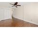 Bedroom features wood flooring, a ceiling fan, and ample closet space at 1701 Palmer Ave, Winter Park, FL 32789