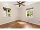 Comfortable bedroom featuring hardwood floors and natural light from two windows at 1701 Palmer Ave, Winter Park, FL 32789