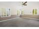 Bright bedroom boasts natural light, neutral carpeting, and a ceiling fan at 1701 Palmer Ave, Winter Park, FL 32789