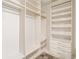 Walk-in closet features an abundance of shelving with gold hanging rods at 1701 Palmer Ave, Winter Park, FL 32789