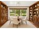 Bright dining room featuring built-in cabinets, a round table with seating for four, and a large window with a view at 1701 Palmer Ave, Winter Park, FL 32789
