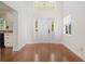 Bright foyer features a soaring ceiling, hardwood floors, and a view into an adjacent kitchen at 1701 Palmer Ave, Winter Park, FL 32789