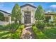 Elegant home entrance with a modern door, manicured landscaping, and symmetrical design at 1701 Palmer Ave, Winter Park, FL 32789