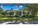 Charming home featuring manicured landscaping, and a striking, modern front door entrance at 1701 Palmer Ave, Winter Park, FL 32789