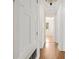 Hallway with hardwood flooring leading to rooms, featuring detailed trim at 1701 Palmer Ave, Winter Park, FL 32789