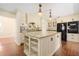 Spacious kitchen features an island with granite countertops, modern appliances, and stylish cabinetry at 1701 Palmer Ave, Winter Park, FL 32789