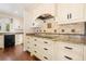 Kitchen with granite countertops, tile backsplash, stainless steel appliances, and custom cabinetry at 1701 Palmer Ave, Winter Park, FL 32789