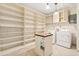 Spacious laundry room with a washer, dryer, and open shelving for storage at 1701 Palmer Ave, Winter Park, FL 32789