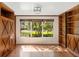 Office featuring built-in bookshelves, hardwood floors and a large window with a view of the outside at 1701 Palmer Ave, Winter Park, FL 32789