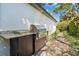 Well-equipped outdoor kitchen with stone path and lush greenery, great for entertaining at 1701 Palmer Ave, Winter Park, FL 32789