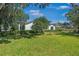 Spacious lawn and home exterior with lush landscaping and mature trees at 1701 Palmer Ave, Winter Park, FL 32789