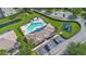 Overhead view of the pool, playground, and parking lot showcases community amenities at 17522 Hidden Forest Dr, Clermont, FL 34714